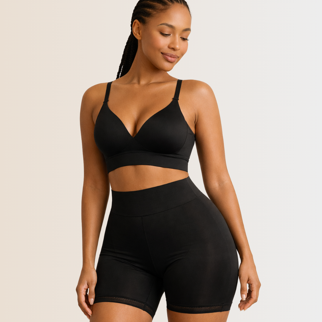 Woman wearing a black bra and shorts set on a plain background