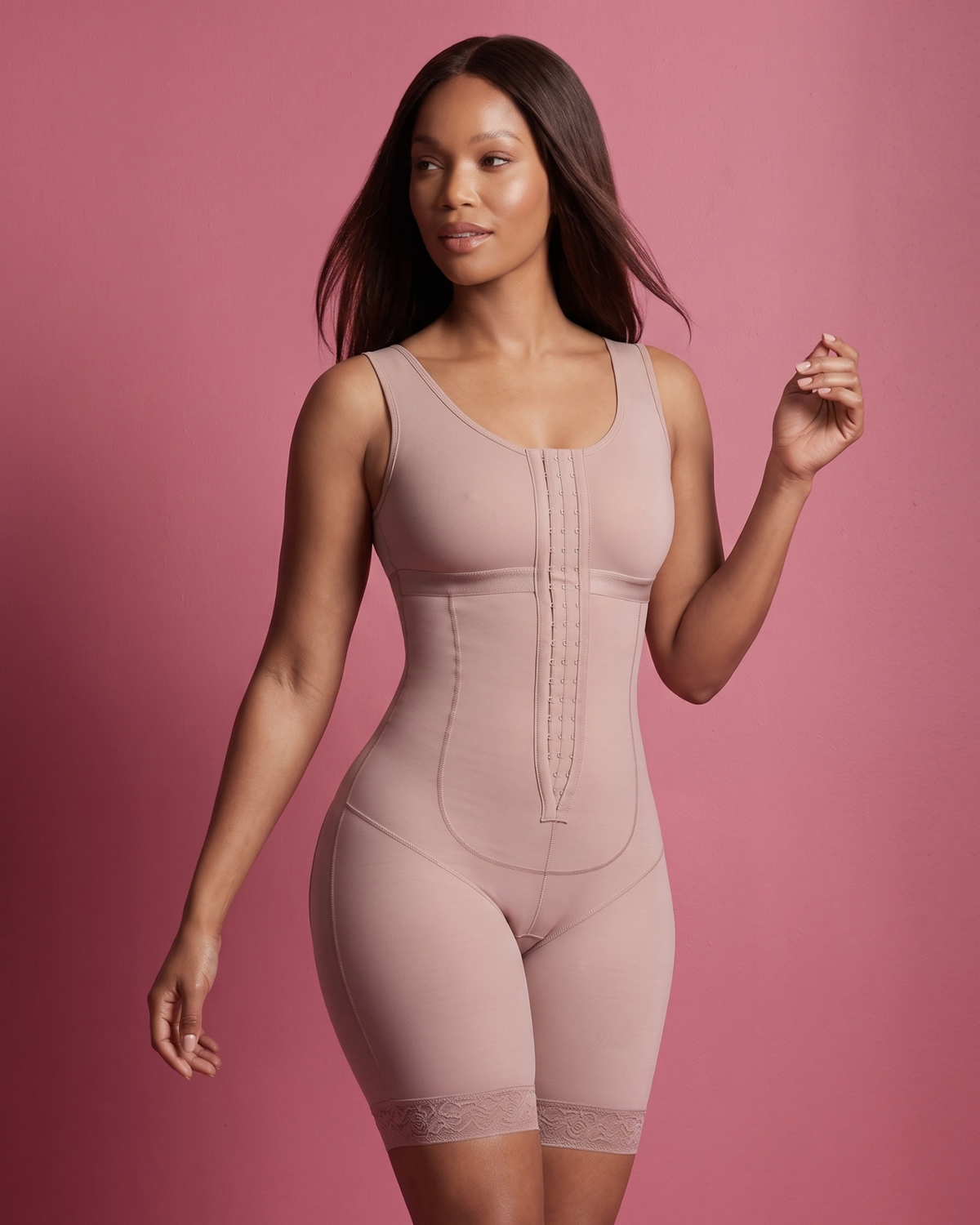 Black women wearing beige shapewear bodysuit against pink background