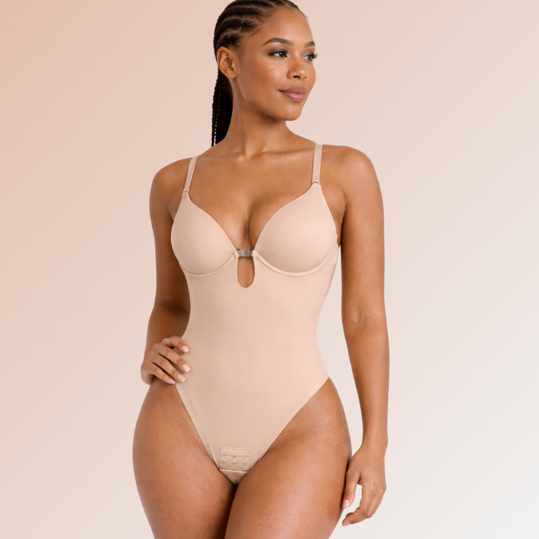 Woman wearing a beige bodysuit against a plain background